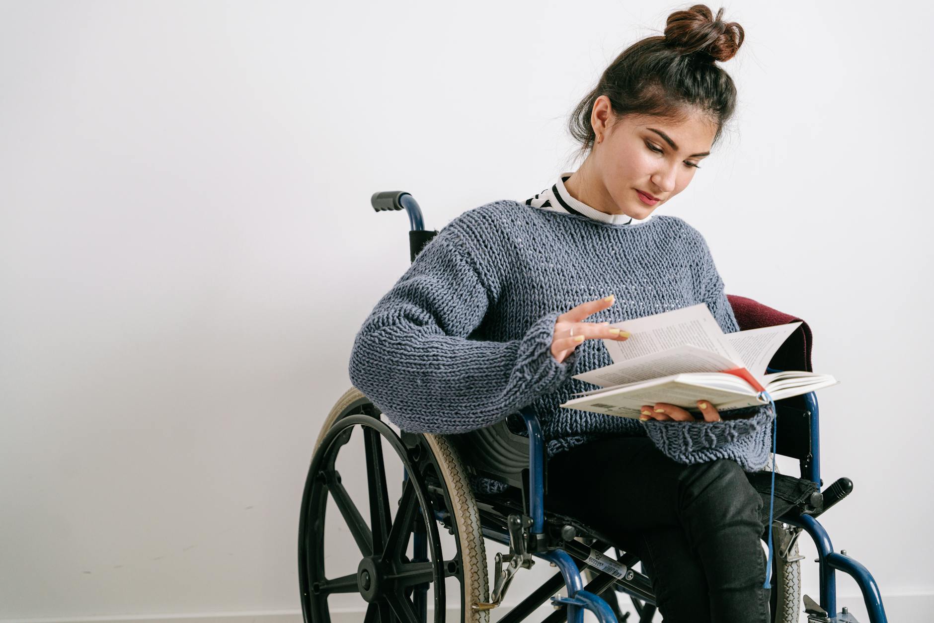 a woman in a sweater reading a book